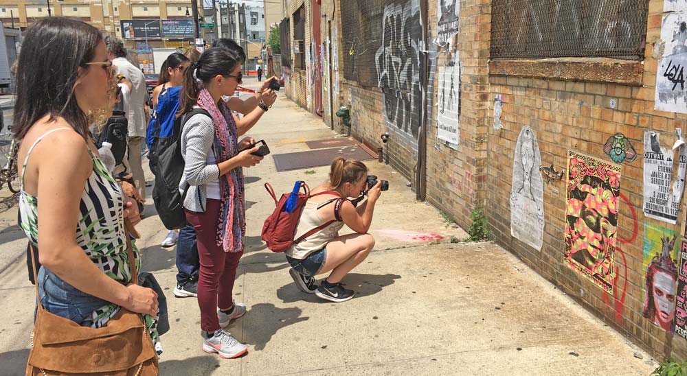 tourists photographing street art